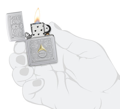 Zippo Vintage Filigree Design Satin Chrome Windproof Lighter lit in hand.