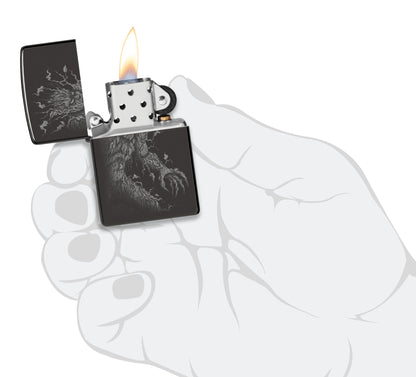 Zippo Root of All Evil Design High Polish Black Windproof Lighter lit in hand.